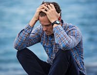 Person sitting outdoors practicing mindfulness to reduce worry and anxiety